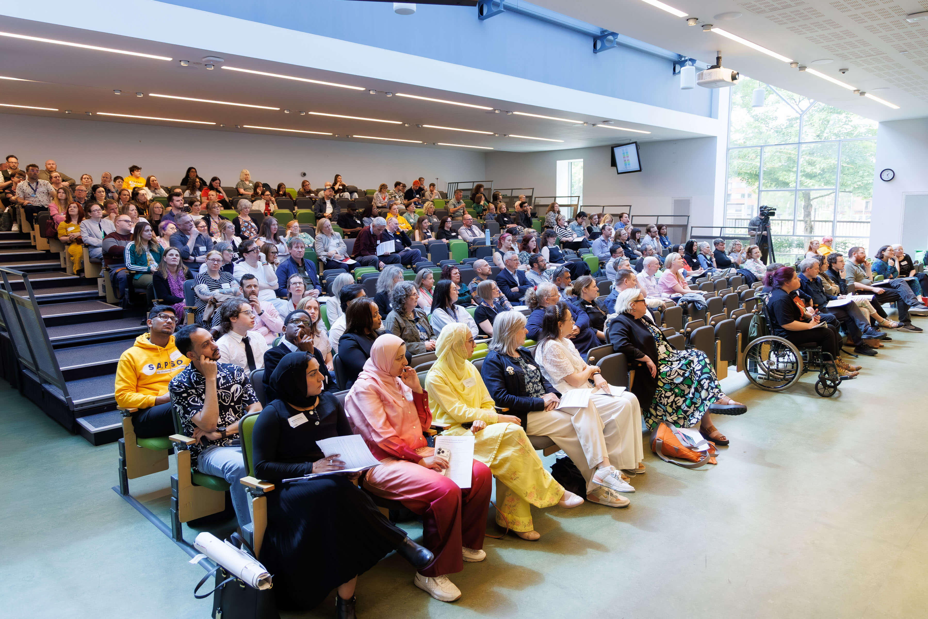A photo of a conference hall filled with delegates